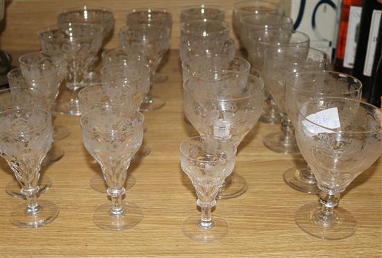 A suite of vine etched cut glass wine and other glasses